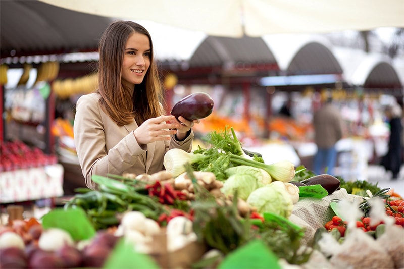 Teen vegan buying vegetables